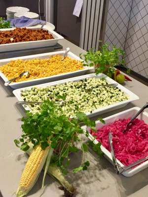 Uppläggningsfat på rad med hackade grönsaker och färs