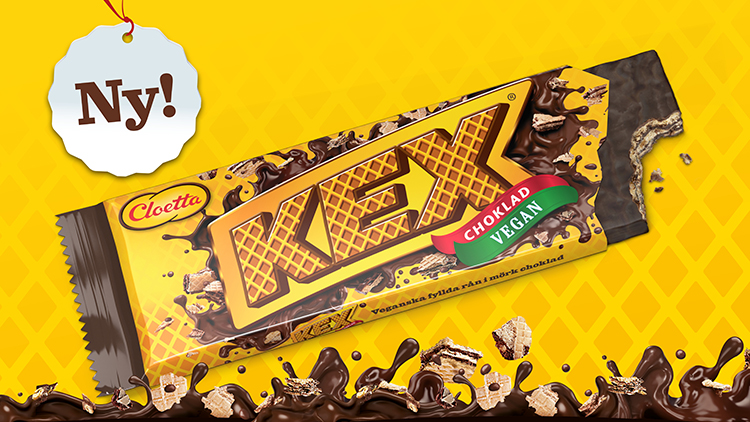 En förpackning Kexchoklad Vegan med texten Ny! ovanför och chokladstäng målade under
